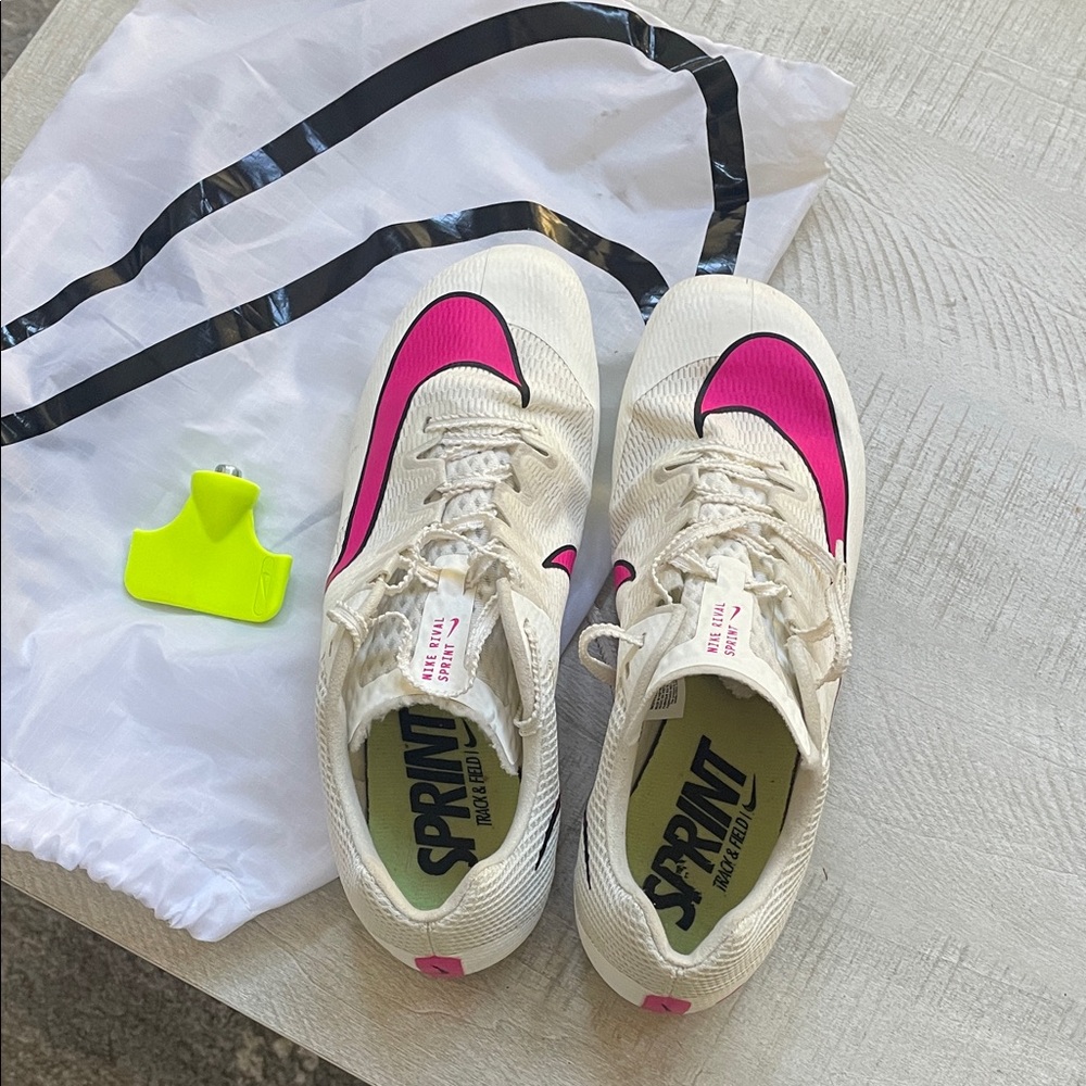 Nike Men’s indoor track with spikes. Athletic Shoes- Cream/pink. Missing 1 spike